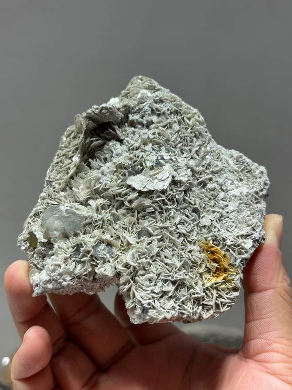 Plate of silvery mica rosettes with aquamarine and scheelite from Xuebaoding, Sichuan, China, reverse side