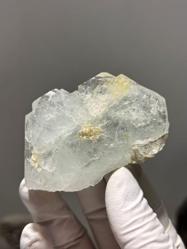 Pale green aquamarine block with golden patch from Xuebaoding, Sichuan, China, close-up of the crystal faces