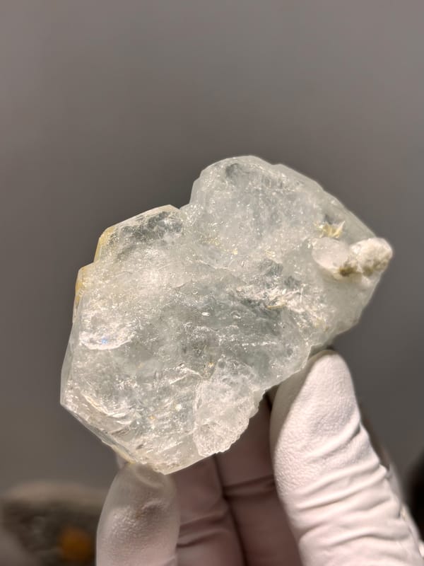 Pale green aquamarine block with golden patch from Xuebaoding, Sichuan, China, reverse side