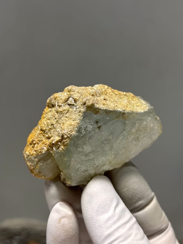 Flat pale green aquamarine with golden mica rim from Xuebaoding, Sichuan, China, second angle
