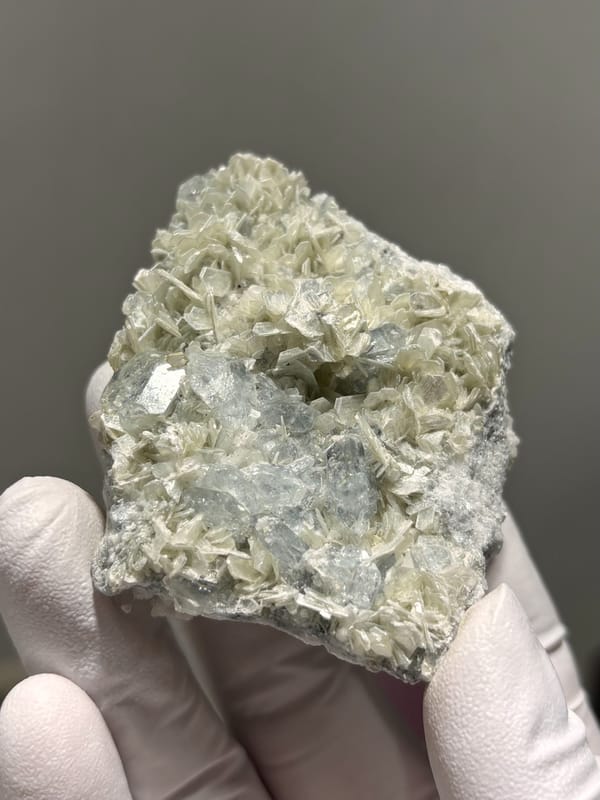 Two-sided pale aquamarine in mica-feldspar plate from Xuebaoding, Sichuan, China, close-up of the crystal faces