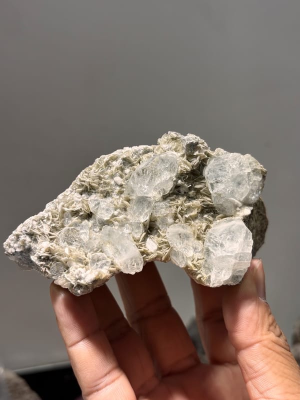 Grey mica plate with pale aquamarine crystals from Xuebaoding, Sichuan, China, close-up of the crystal faces