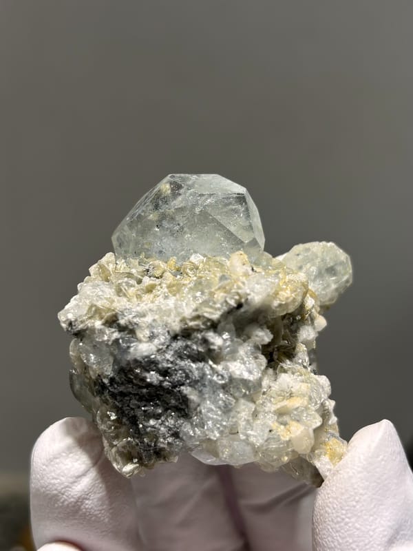Pale blue aquamarine over white mica and feldspar from Xuebaoding, Sichuan, China, close-up of the crystal faces