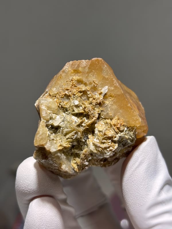 Large honey-orange scheelite on tan mica from Xuebaoding, Sichuan, China, second angle