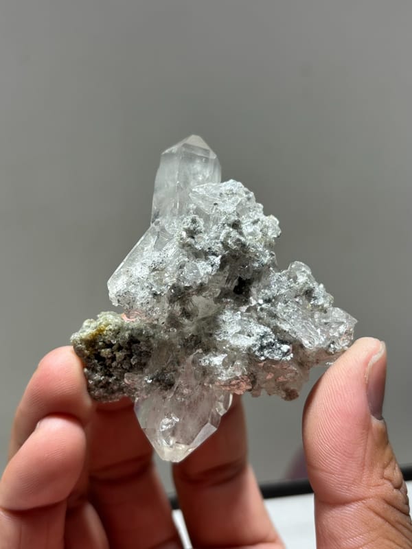 Clear quartz cluster with mica and dark flecks from Xuebaoding, Sichuan, China, second angle