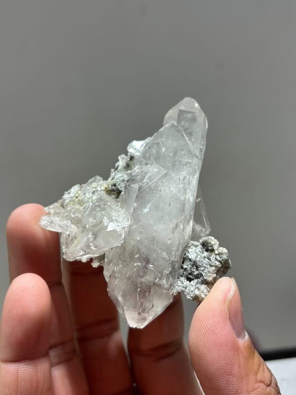 Clear quartz cluster with mica and dark flecks from Xuebaoding, Sichuan, China, top view