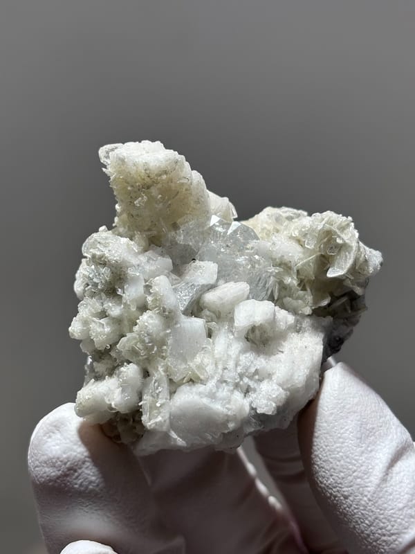 White feldspar cluster with aquamarine, mica and quartz from Xuebaoding, Sichuan, China, second angle