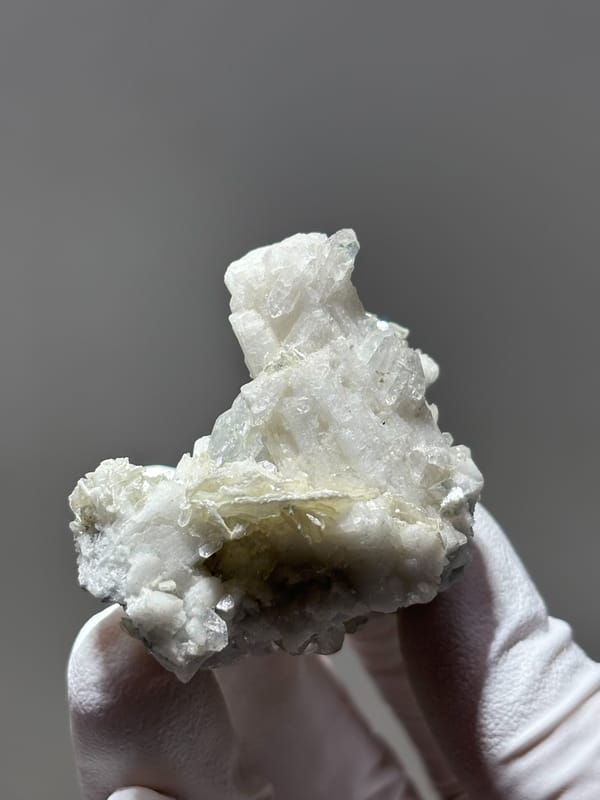 White feldspar cluster with aquamarine, mica and quartz from Xuebaoding, Sichuan, China, reverse side