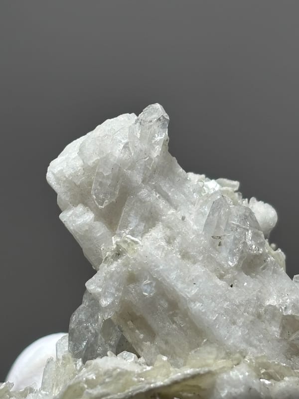 White feldspar cluster with aquamarine, mica and quartz from Xuebaoding, Sichuan, China, top view