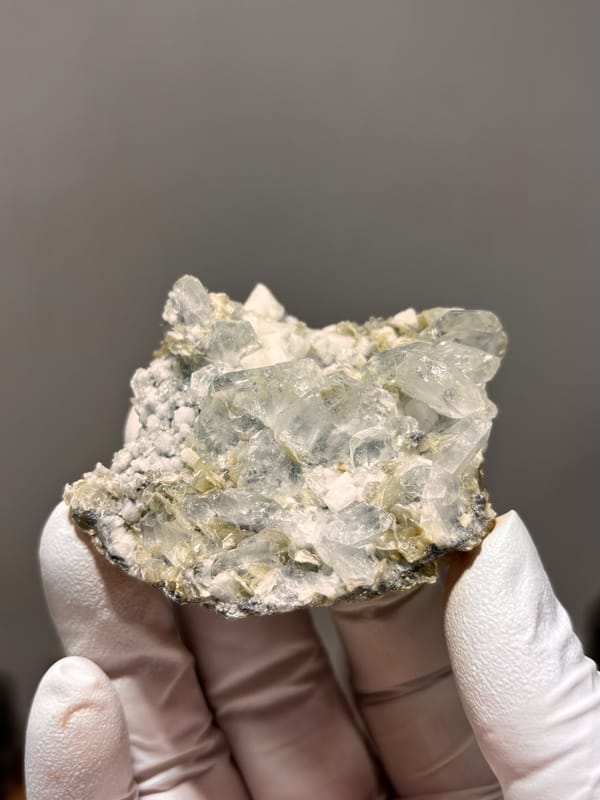 Pale aquamarine cluster over white feldspar and mica from Xuebaoding, Sichuan, China, second angle