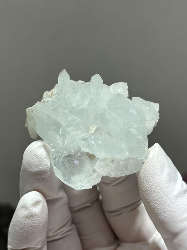 Pale aquamarine crystal group with floater base from Xuebaoding, Sichuan, China, close-up of the crystal faces