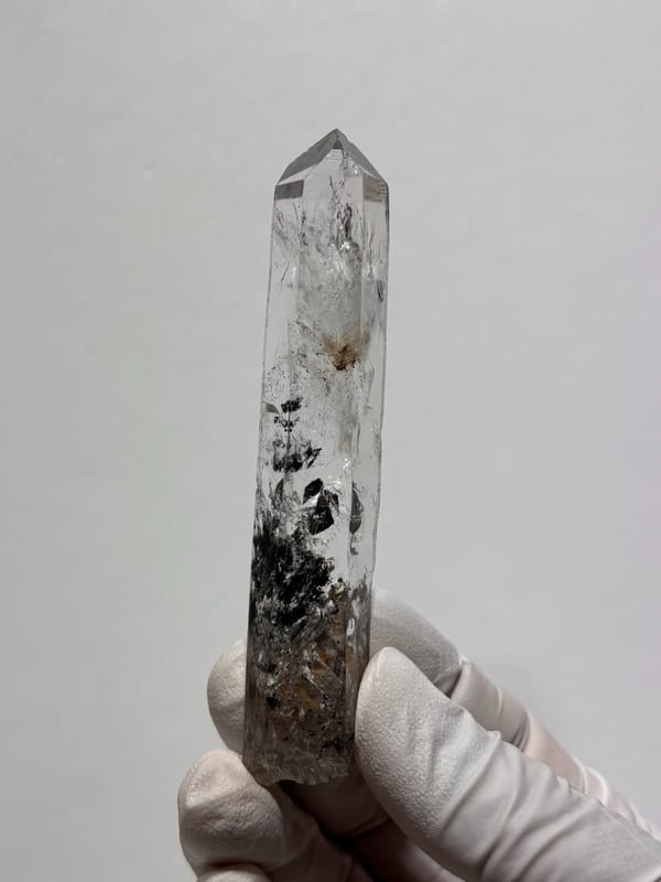 Black-included quartz wand from Jinkouhe, Sichuan, China, close-up of the crystal faces