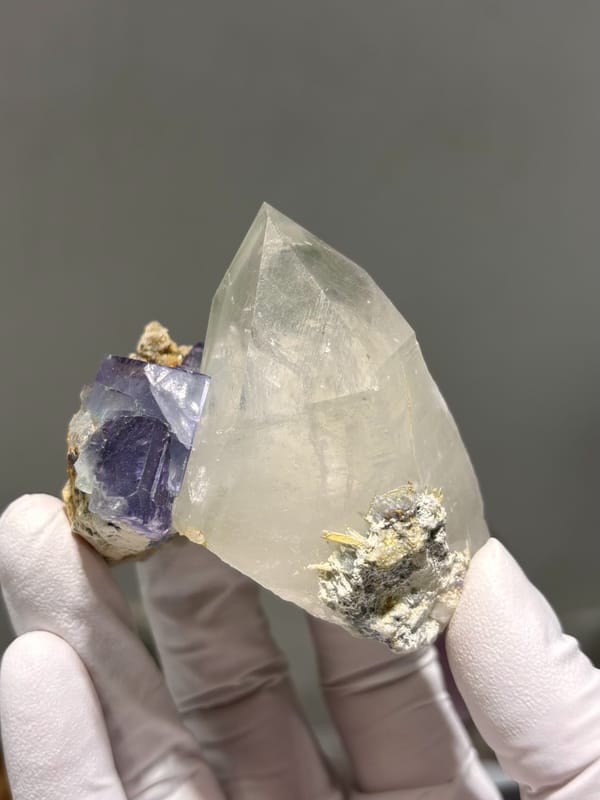 Clear quartz point with purple fluorite cube from Yaogangxian, Hunan, China, reverse side