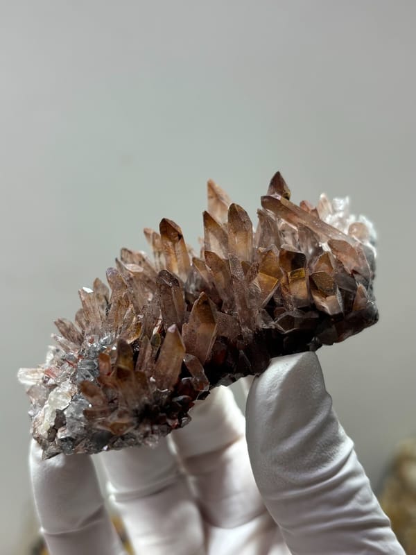 Red-skinned quartz cluster from Guangdong, China, close-up of the crystal faces
