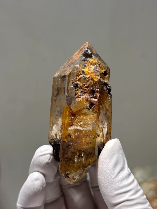 Himalayan quartz with rusty coat and complete tip, top view