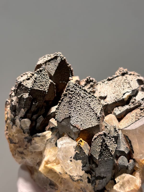 Madagascan quartz cluster with hematite-coated tips, close-up of the crystal faces