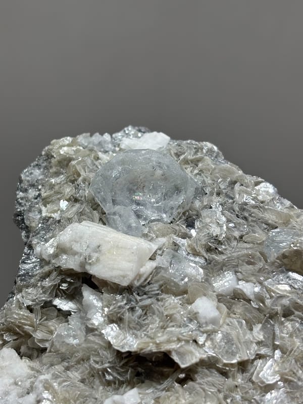Pale aquamarine in grey mica with white feldspar from Xuebaoding, Sichuan, China, second angle