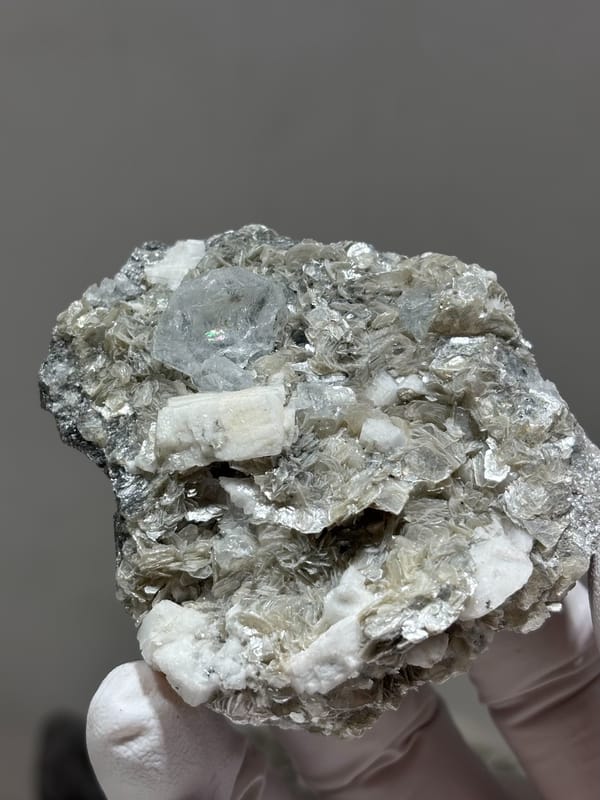 Pale aquamarine in grey mica with white feldspar from Xuebaoding, Sichuan, China, reverse side