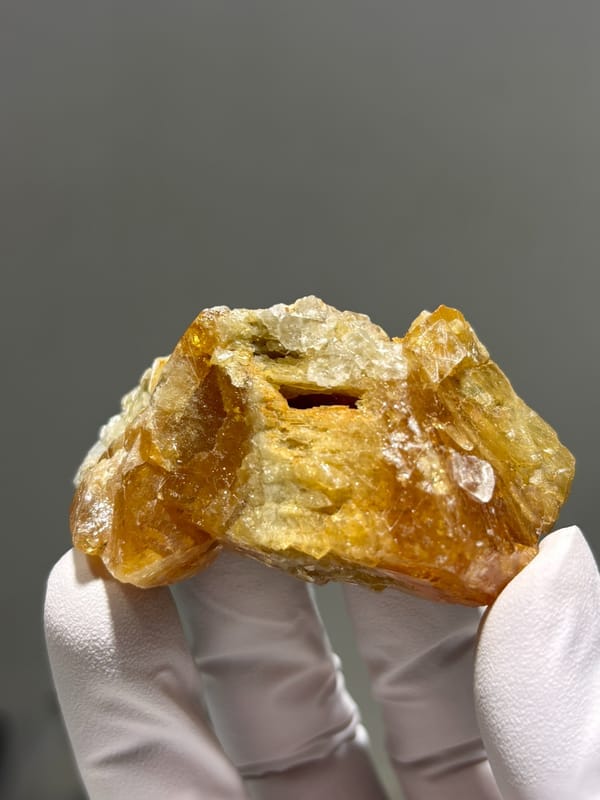 Orange scheelite floater from Xuebaoding, Sichuan, China, second angle