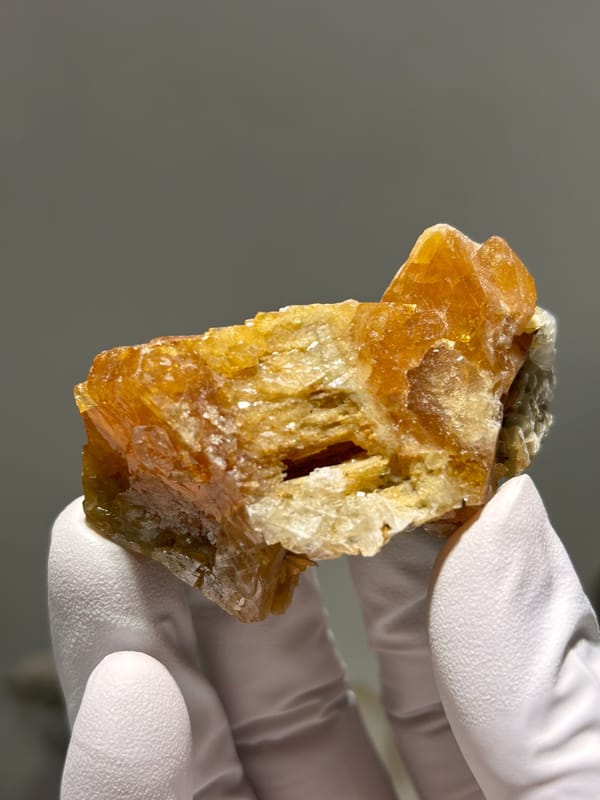 Orange scheelite floater from Xuebaoding, Sichuan, China, reverse side