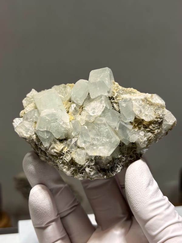 Pale aquamarine prisms lying on grey mica from Xuebaoding, Sichuan, China, second angle