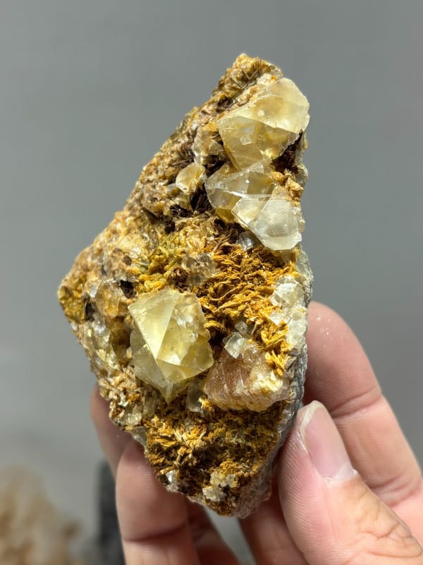 Pale fluorite crystals with scheelite in golden mica from Xuebaoding, Sichuan, China, second angle
