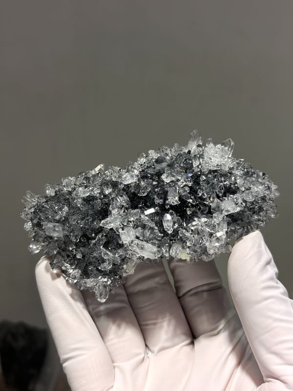 Plate of quartz on prehnite from Yunnan, China, close-up of the crystal faces