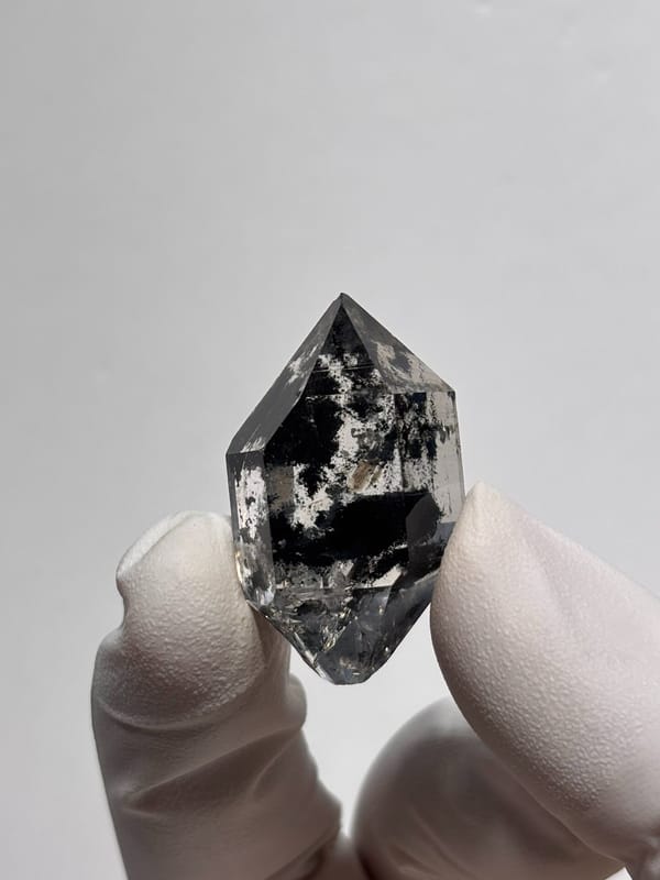 Scattered-ink double-terminated quartz from Chongqing, China, close-up of the crystal faces
