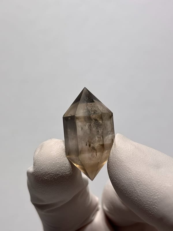 Tiny smoky double-terminated quartz with phantom from Yunnan, China, close-up of the crystal faces