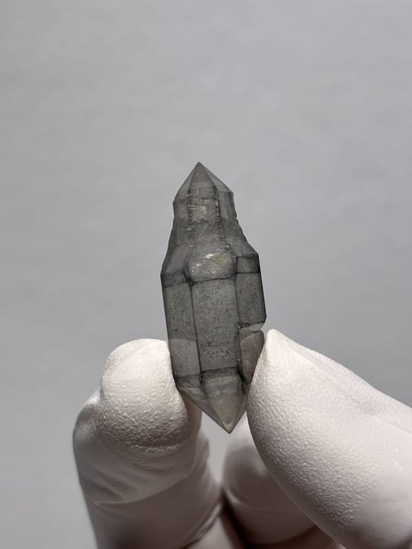 Grey sketch-pattern double-terminated quartz with sceptre tip from Yunnan, China, close-up of the crystal faces