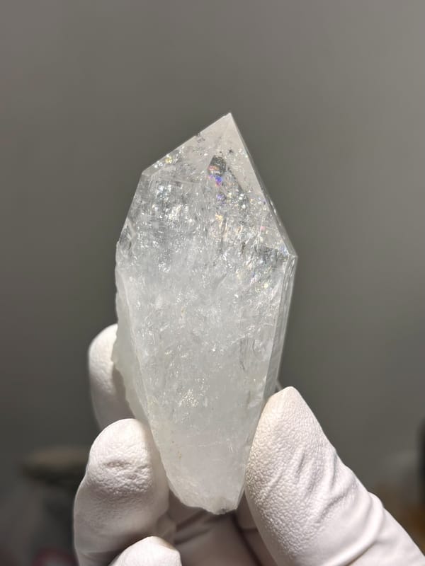 Icy clear quartz point with rainbow flash from Jinkouhe, Sichuan, China, reverse side