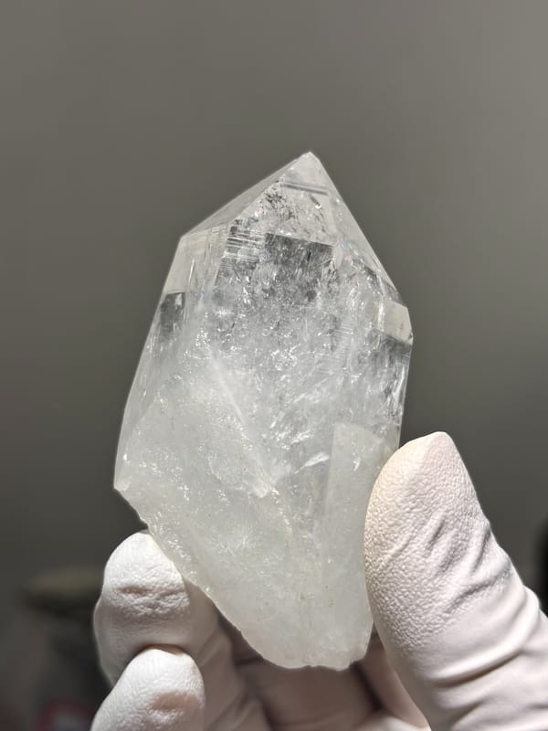 Icy clear quartz point with rainbow flash from Jinkouhe, Sichuan, China, top view