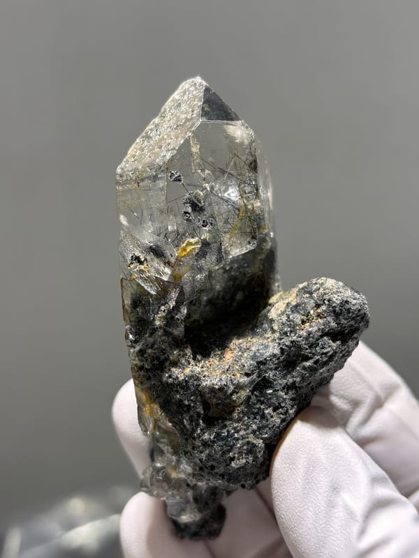 Smoky quartz point with black rutile on dark base from Xuebaoding, Sichuan, China, second angle