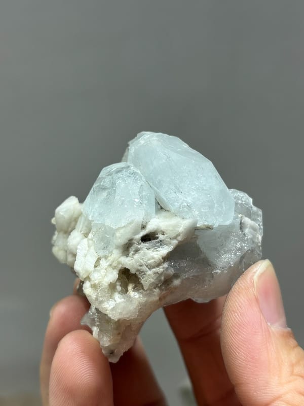Pale blue aquamarine on white feldspar and mica from Xuebaoding, Sichuan, China, second angle