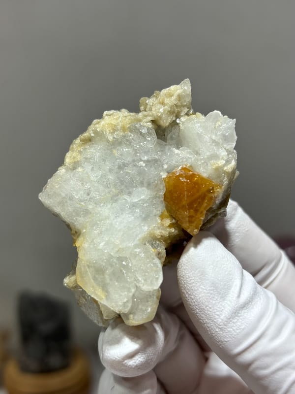 Pale aquamarine cluster with orange scheelite crystal from Xuebaoding, Sichuan, China, reverse side