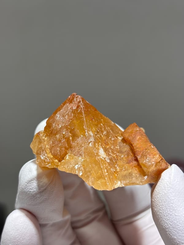 Orange scheelite crystal with glassy faces from Xuebaoding, Sichuan, China, second angle