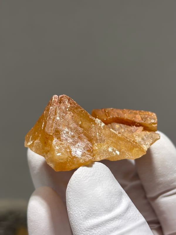 Orange scheelite crystal with glassy faces from Xuebaoding, Sichuan, China, reverse side
