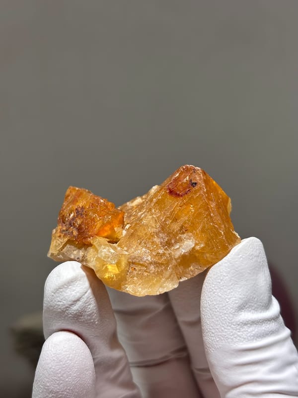 Orange scheelite crystal with glassy faces from Xuebaoding, Sichuan, China, top view