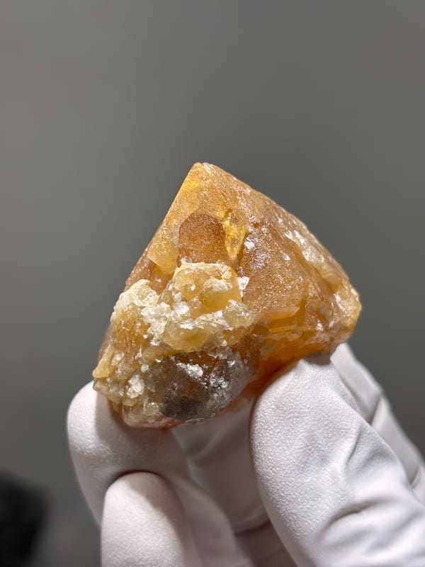 Large honey-orange scheelite crystal from Xuebaoding, Sichuan, China, close-up of the crystal faces
