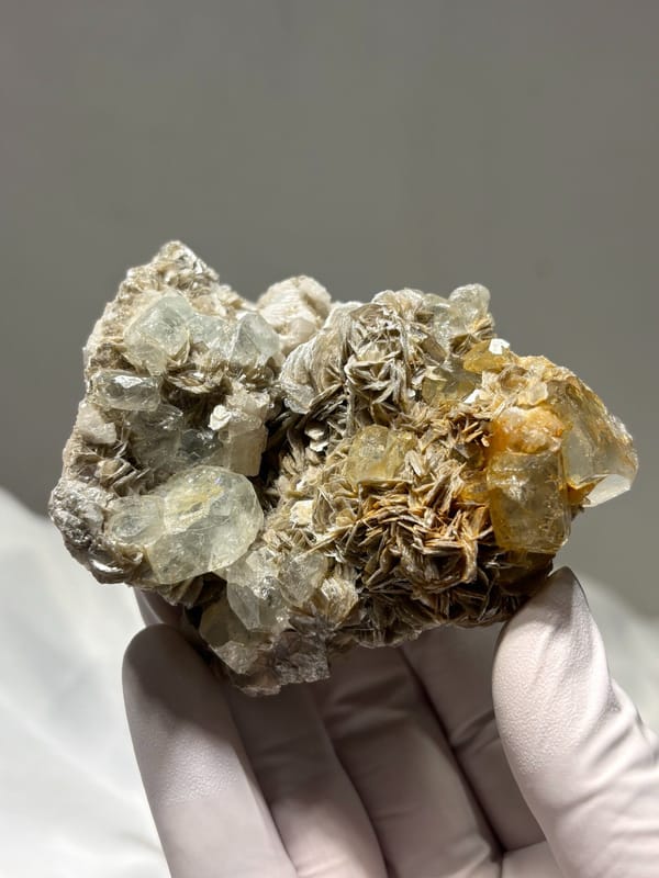 Quartz and aquamarine cluster on golden mica from Xuebaoding, Sichuan, China, close-up of the crystal faces