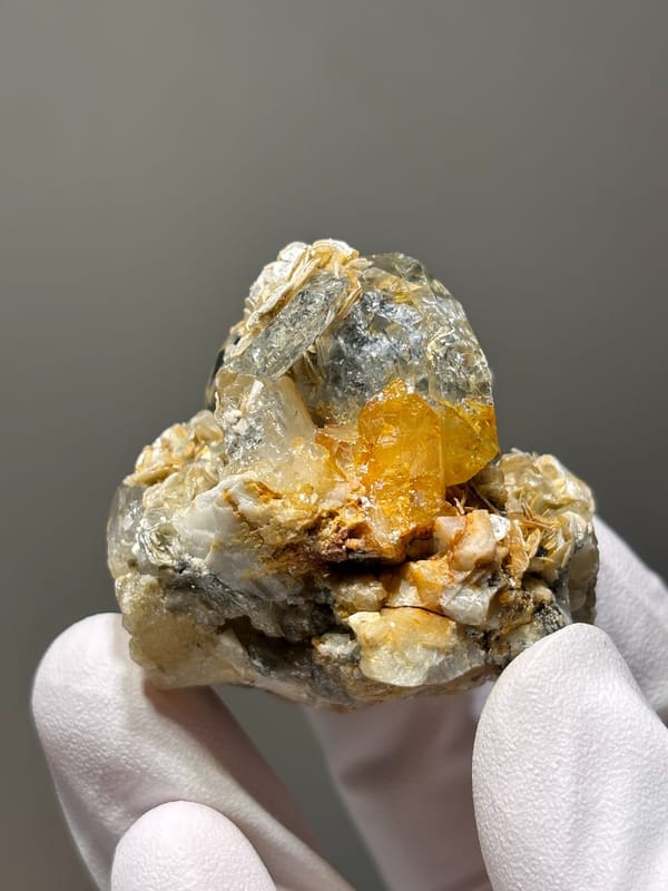Aquamarine cluster with mica, scheelite and feldspar from Xuebaoding, Sichuan, China, close-up of the crystal faces