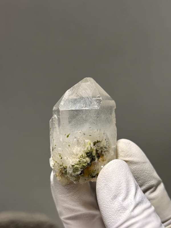 Clear garden quartz point with floater base from Sichuan, China, close-up of the crystal faces