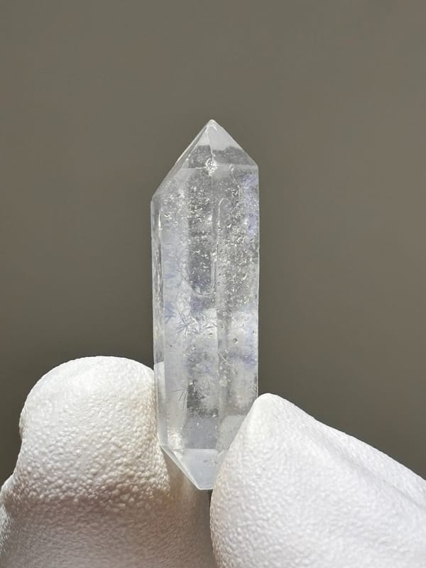 Tiny dumortierite-in-quartz double-terminated crystal from Brazil, top view