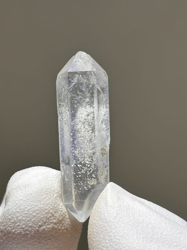 Tiny dumortierite-in-quartz double-terminated crystal from Brazil, detail of the matrix contact