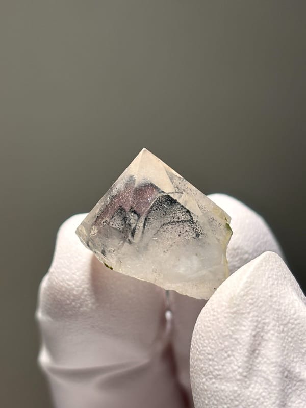 Tiny garden quartz with green epidote specks from Sichuan, China, close-up of the crystal faces