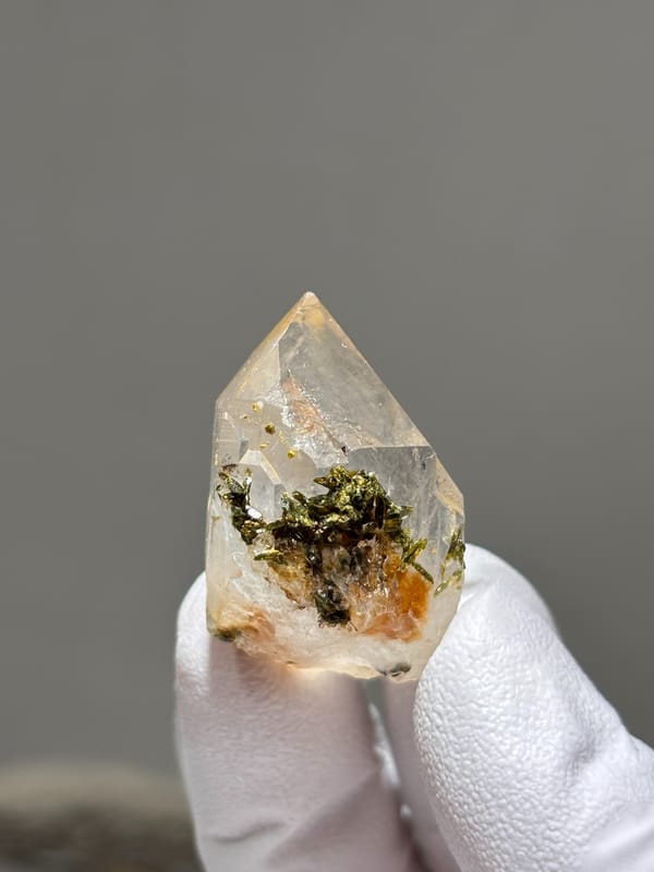 Garden quartz with green and orange inclusions from Jinkouhe, Sichuan, China, close-up of the crystal faces