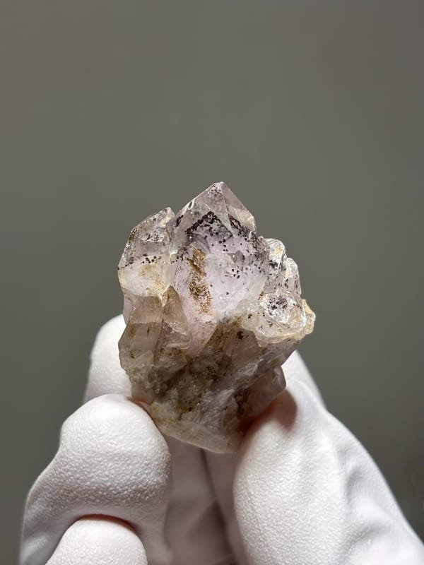 Garden quartz with black specks and pink tint from Sichuan, China, close-up of the crystal faces