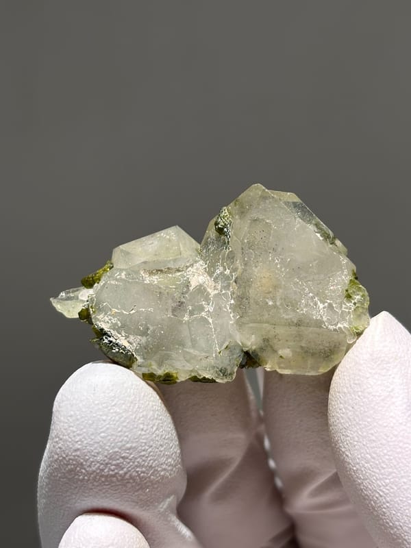 Flat garden quartz with green epidote sprays from Sichuan, China, close-up of the crystal faces