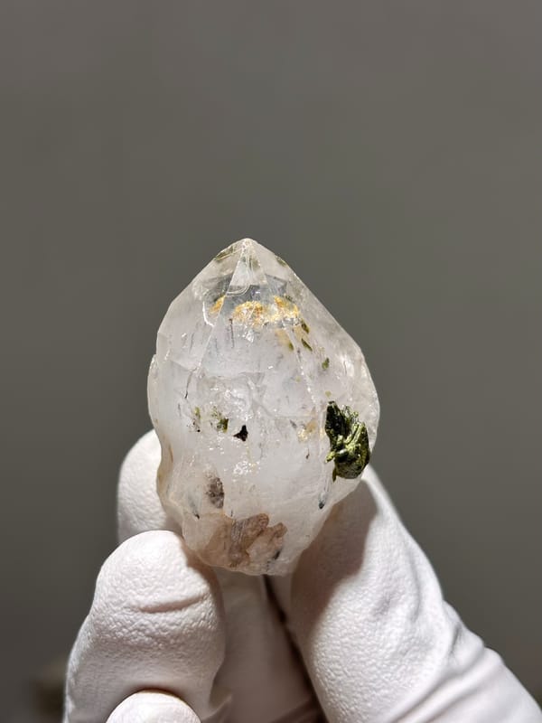 Garden quartz point with green epidote inclusion from Sichuan, China, close-up of the crystal faces