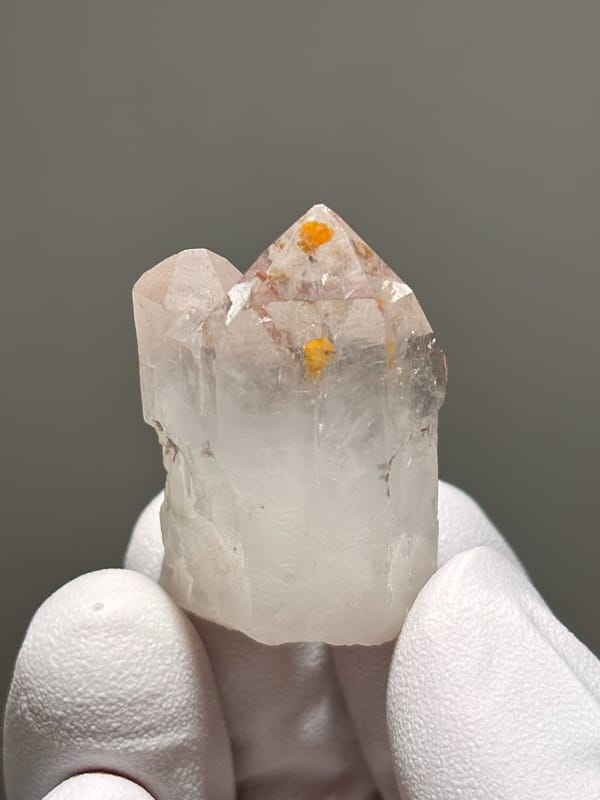 Garden quartz with orange specks inside from Sichuan, China, close-up of the crystal faces